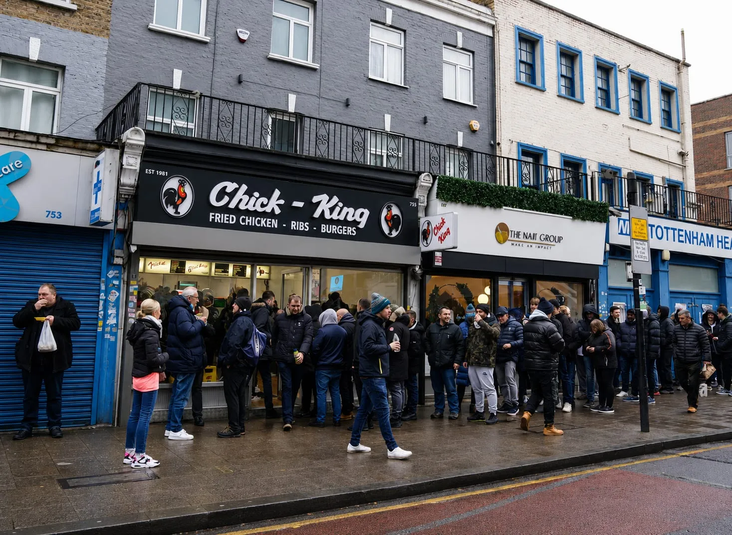 A long queue of supporters outside Chick King on Tottenham High Road before a match