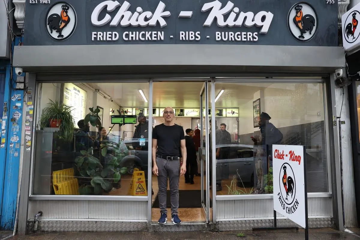 The open doorway of Chick King with a member of the team in the entrance